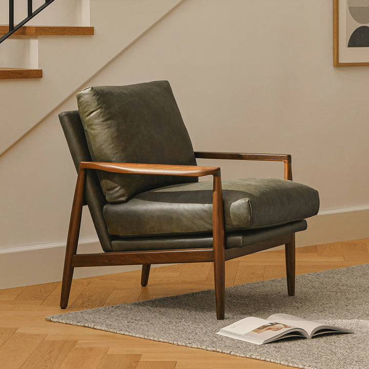 Aurelia Leather Lounge Chair with walnut legs in a sunlit mid-century modern living room