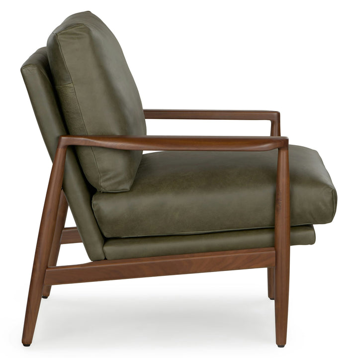 Aurelia Leather Lounge Chair with walnut legs in a sunlit mid-century modern living room