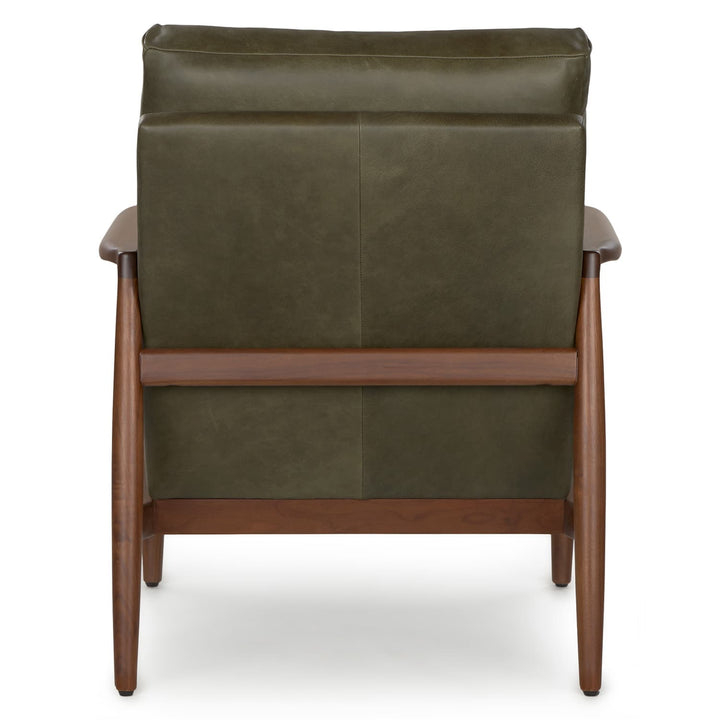 Aurelia Leather Lounge Chair with walnut legs in a sunlit mid-century modern living room