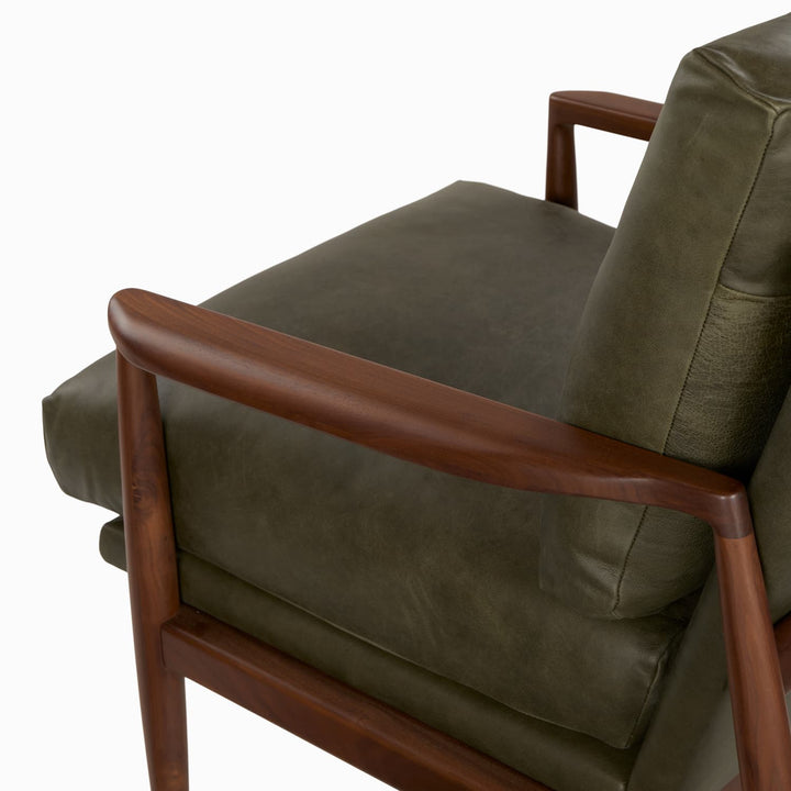 Aurelia Leather Lounge Chair with walnut legs in a sunlit mid-century modern living room