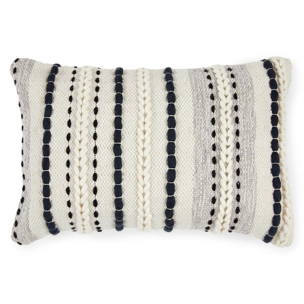 Caelis Pillow on a neutral sofa with Moroccan-inspired weaving and wool shell