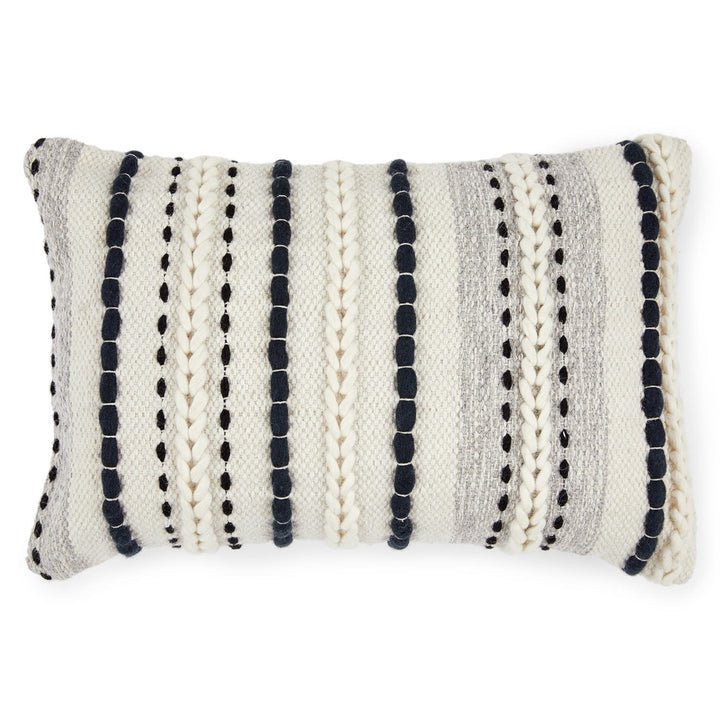 Caelis Pillow on a neutral sofa with Moroccan-inspired weaving and wool shell
