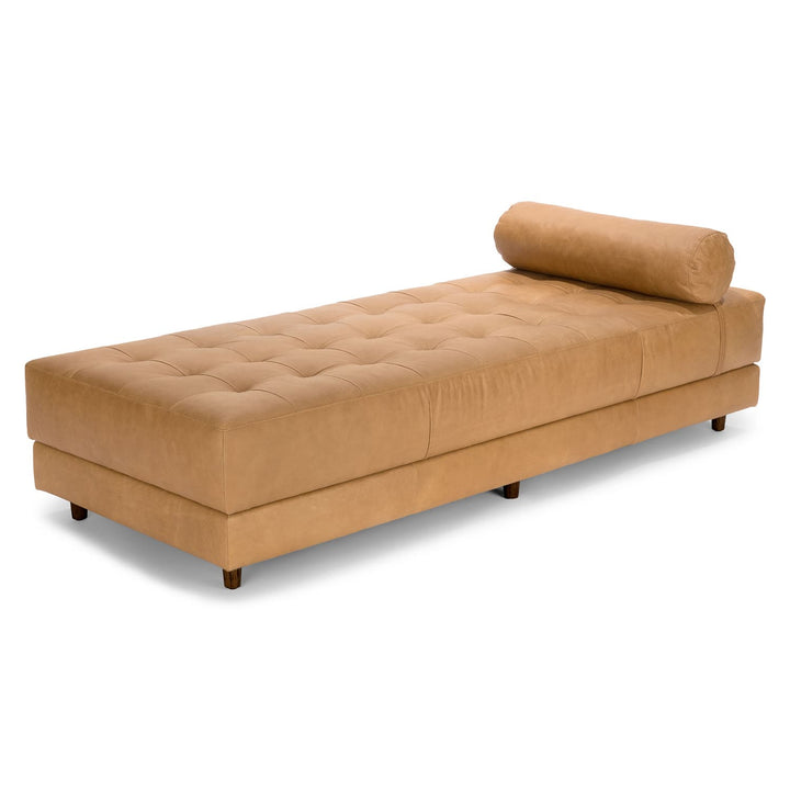 Caelum Leather Chaise Lounge in a sunlit mid-century modern living room with vintage rug