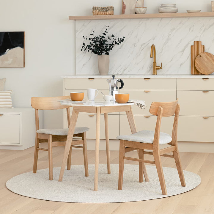Calypso Cafe Table with marble top and wood legs in a cozy breakfast nook