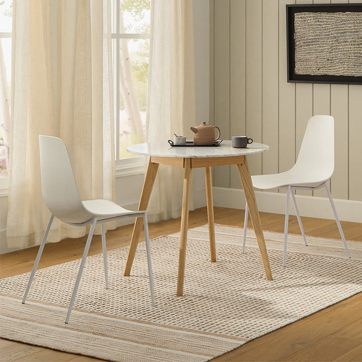 Calypso Cafe Table with marble top and wood legs in a cozy breakfast nook
