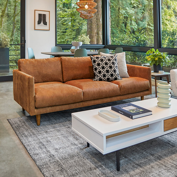 Chambers Leather Sofa in aged tan leather with sheepskin throw in industrial loft interior