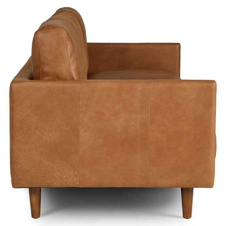 Chambers Leather Sofa in aged tan leather with sheepskin throw in industrial loft interior