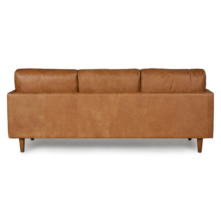 Chambers Leather Sofa in aged tan leather with sheepskin throw in industrial loft interior
