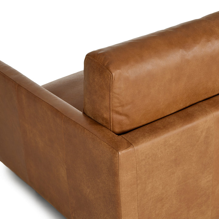 Chambers Leather Sofa in aged tan leather with sheepskin throw in industrial loft interior