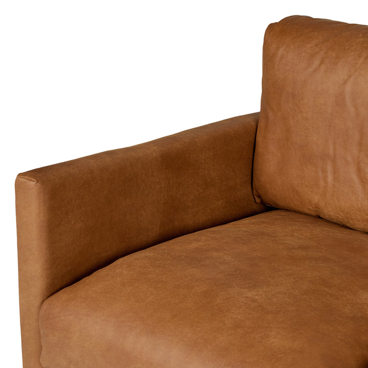Chambers Leather Sofa in aged tan leather with sheepskin throw in industrial loft interior