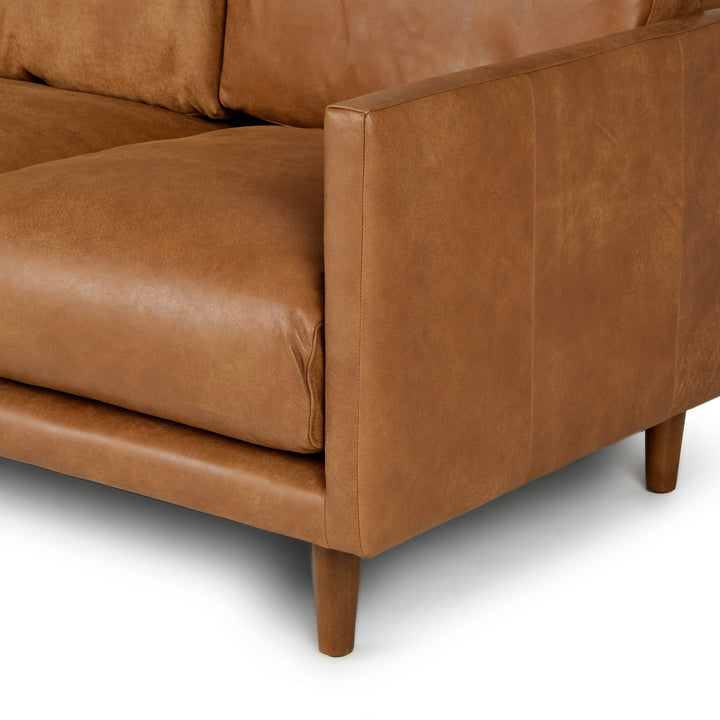 Chambers Leather Sofa in aged tan leather with sheepskin throw in industrial loft interior