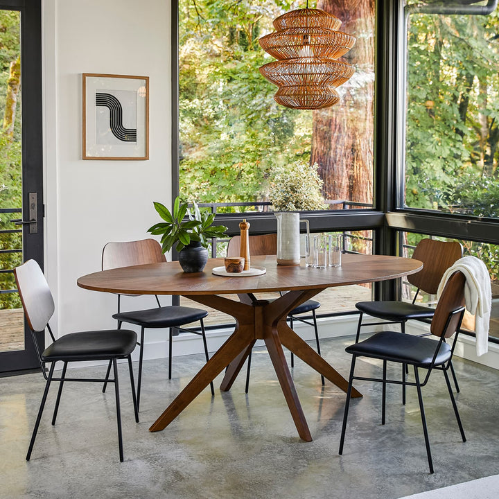 Cyrene Oval Dining Table with starburst walnut veneer in a mid-century modern dining room