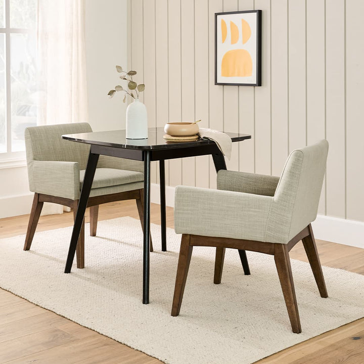 Fauces Dining Armchair pair in a modern dining room with splayed legs and upholstered seats