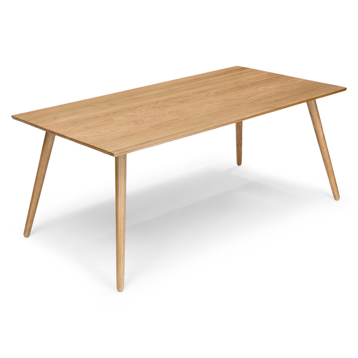 Iris Dining Table in a mid-century modern dining room with solid wood legs and natural wood grain