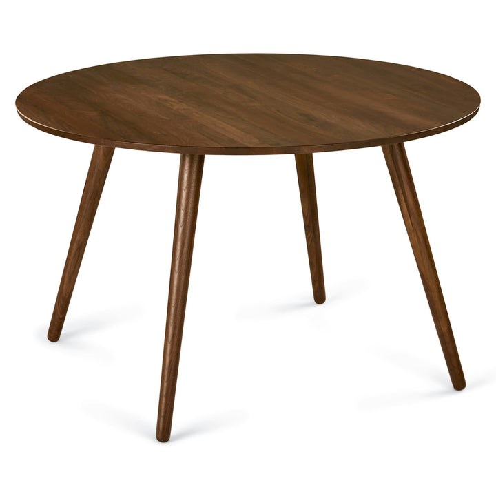 Iris Dining Table in a mid-century modern dining room with solid wood legs and natural wood grain