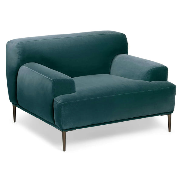 Lumina Velvet Lounge Chair in emerald velvet with titanium legs, showcasing draped-leg lounging posture