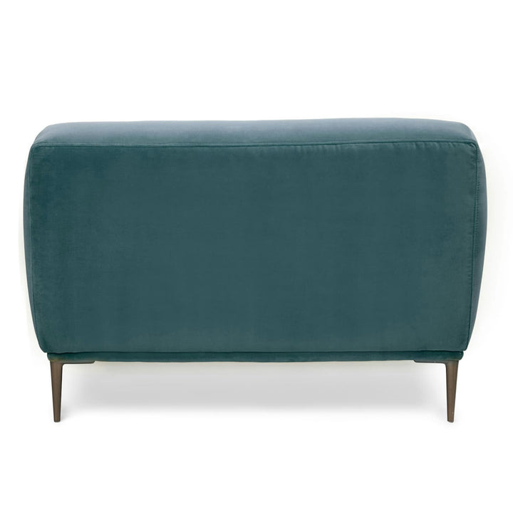 Lumina Velvet Lounge Chair in emerald velvet with titanium legs, showcasing draped-leg lounging posture
