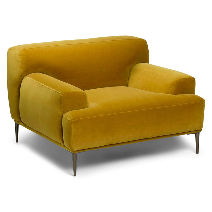 Lumina Velvet Lounge Chair in emerald velvet with titanium legs, showcasing draped-leg lounging posture