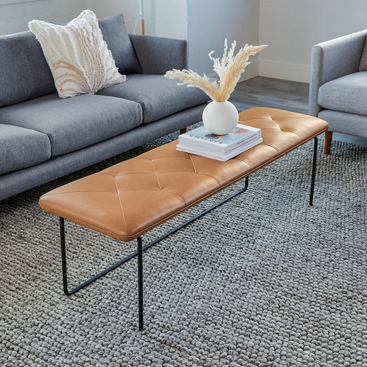 Lyngen Leather Bench with tufted Bella leather and curved steel legs in a modern dining area