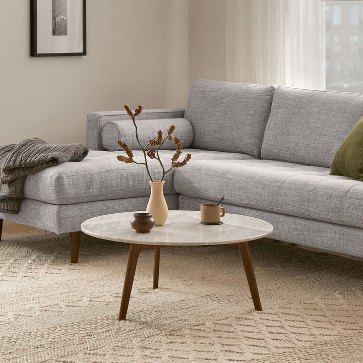 MORA Marble Coffee Table in walnut finish beside sofa with dog bed nearby