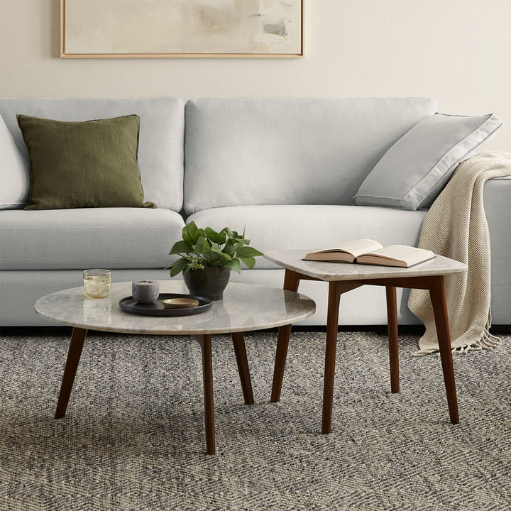 MORA Marble Coffee Table in walnut finish beside sofa with dog bed nearby