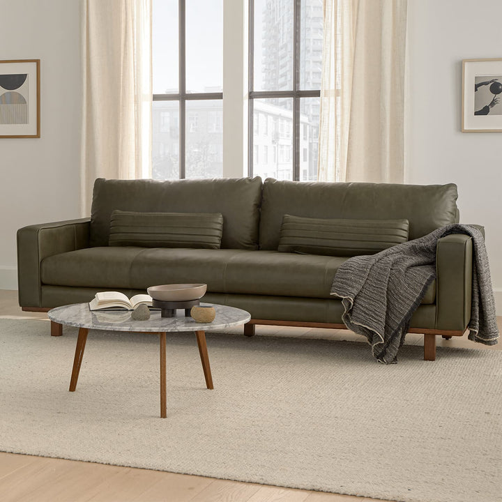 MORA Marble Coffee Table in walnut finish beside sofa with dog bed nearby