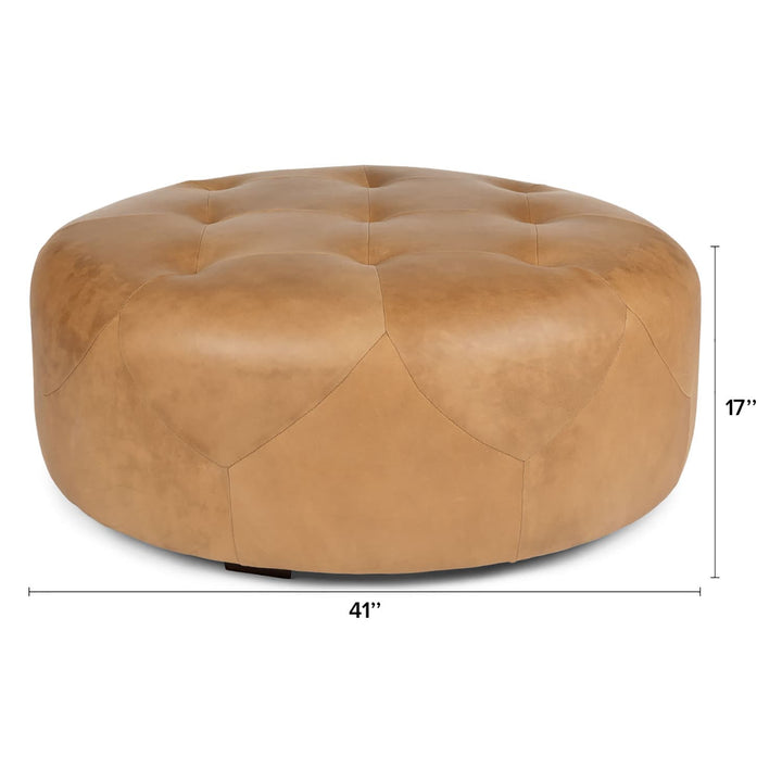 Mohn Leather Ottoman in a modern living room as a tufted leather footrest and coffee table
