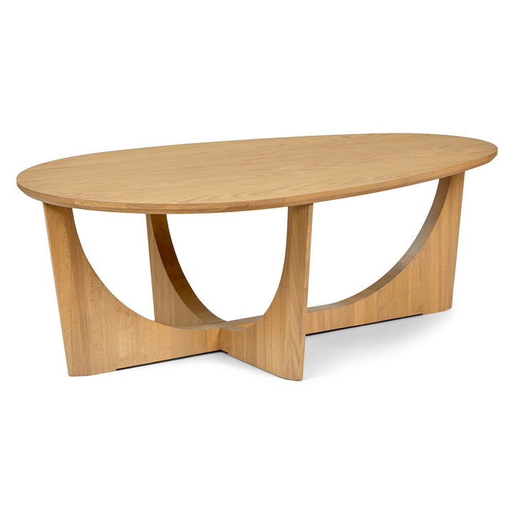NORDI Coffee Table with sculpted base and natural wood grain in a modern living room