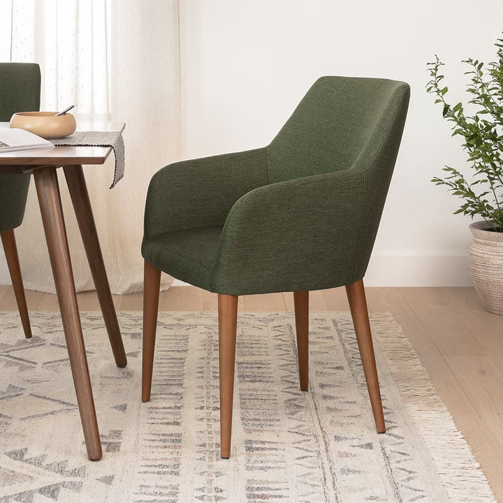 Navi Dining Chair in a modern dining room with walnut legs and upholstered seating