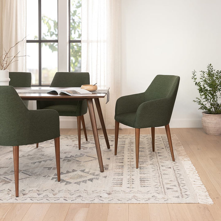 Navi Dining Chair in a modern dining room with walnut legs and upholstered seating