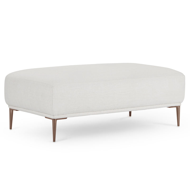 Nordkapp Ottoman with linen-blend upholstery and brushed aluminum legs in a modern living room