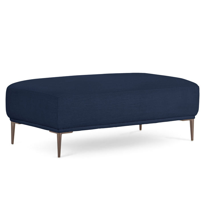 Nordkapp Ottoman with linen-blend upholstery and brushed aluminum legs in a modern living room