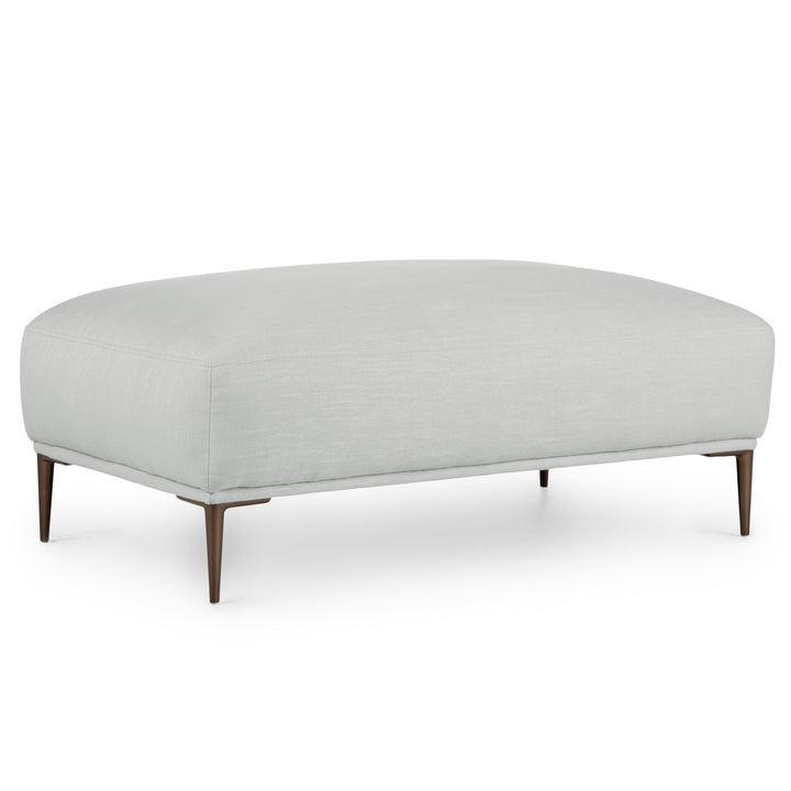 Nordkapp Ottoman with linen-blend upholstery and brushed aluminum legs in a modern living room