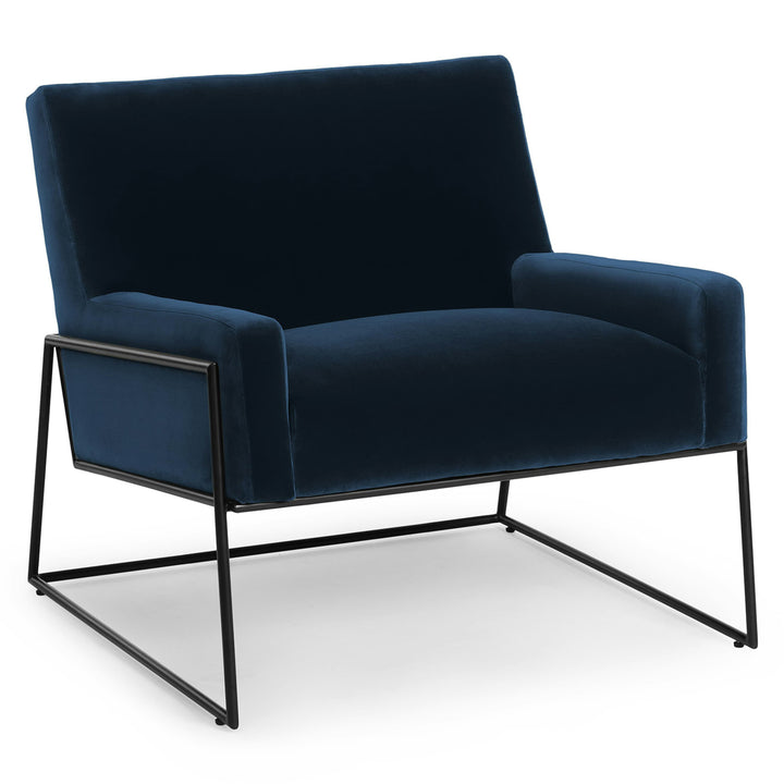 Ondine Blue Velvet Lounge Chair in emerald with gold legs in a modern loft setting