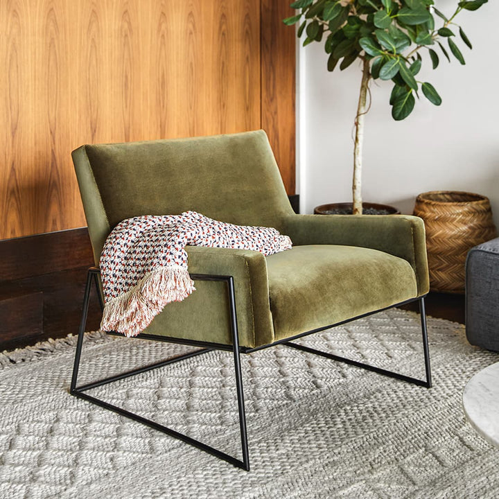 Ondine Green Velvet Lounge Chair in emerald with gold legs in a modern loft setting