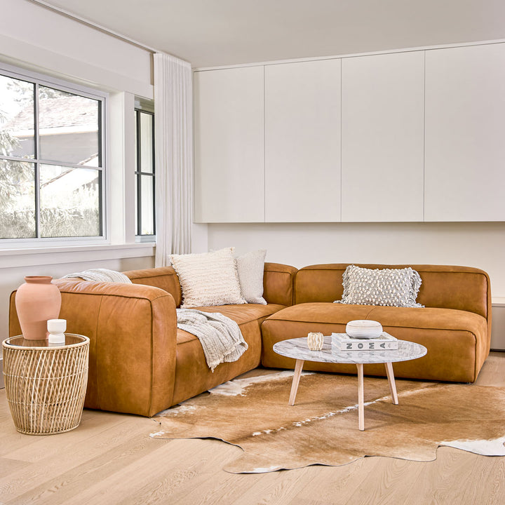 Pembroke Leather Sectional in rawhide tan with laptop in home office setting