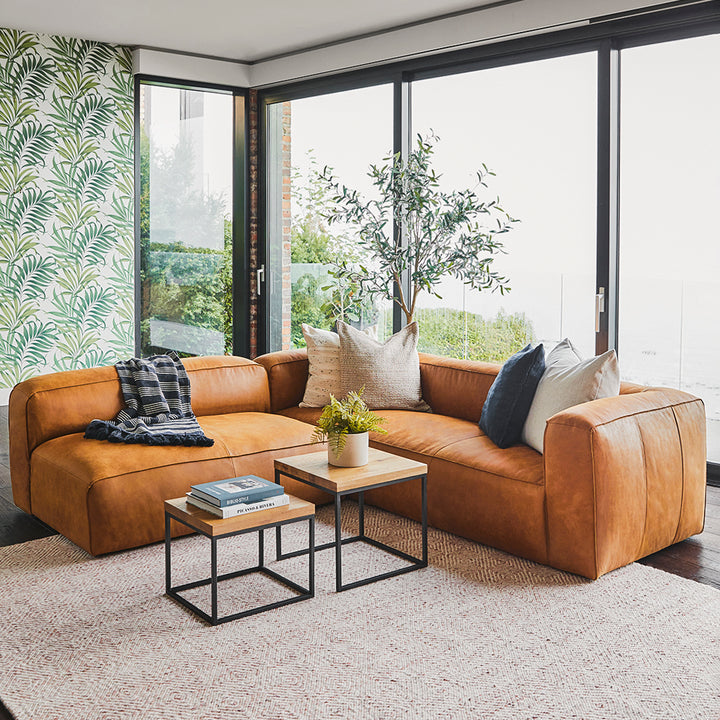 Pembroke Leather Sectional in rawhide tan with laptop in home office setting