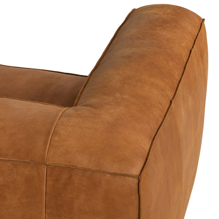 Pembroke Leather Sectional in rawhide tan with laptop in home office setting