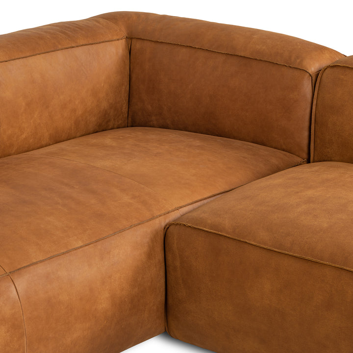 Pembroke Leather Sectional in rawhide tan with laptop in home office setting