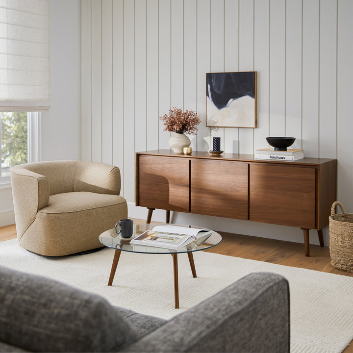 RA Glass Coffee Table with transparent tempered glass top and walnut-stained oak legs in a modern living room