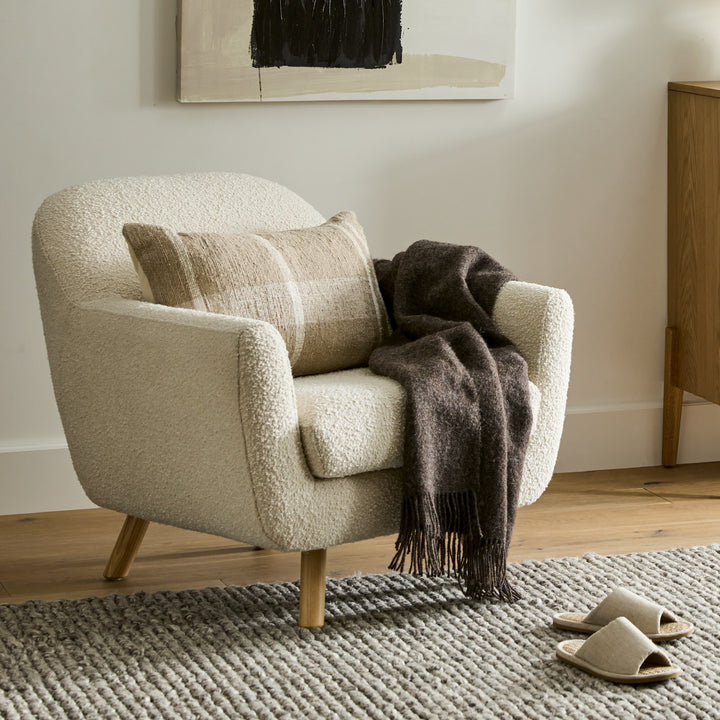 Santorini bouclé lounge chair in emerald green with curved wood frame in modern living room
