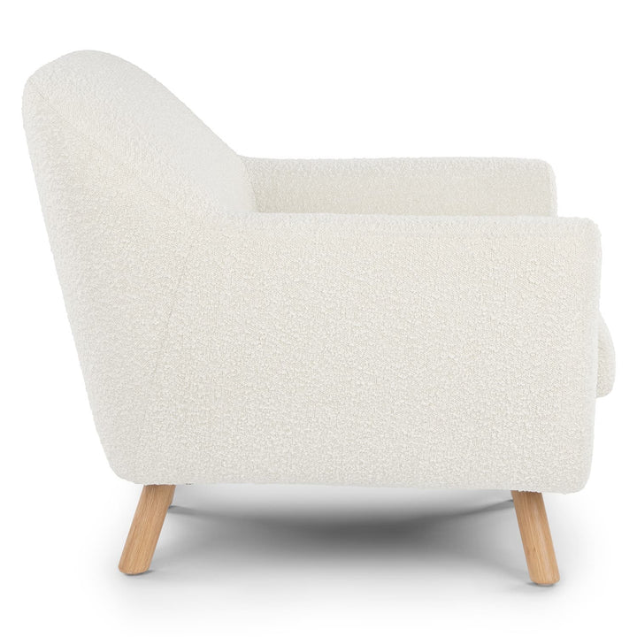 Santorini bouclé lounge chair in emerald green with curved wood frame in modern living room