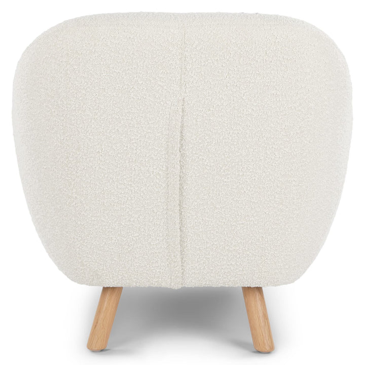 Santorini bouclé lounge chair in emerald green with curved wood frame in modern living room