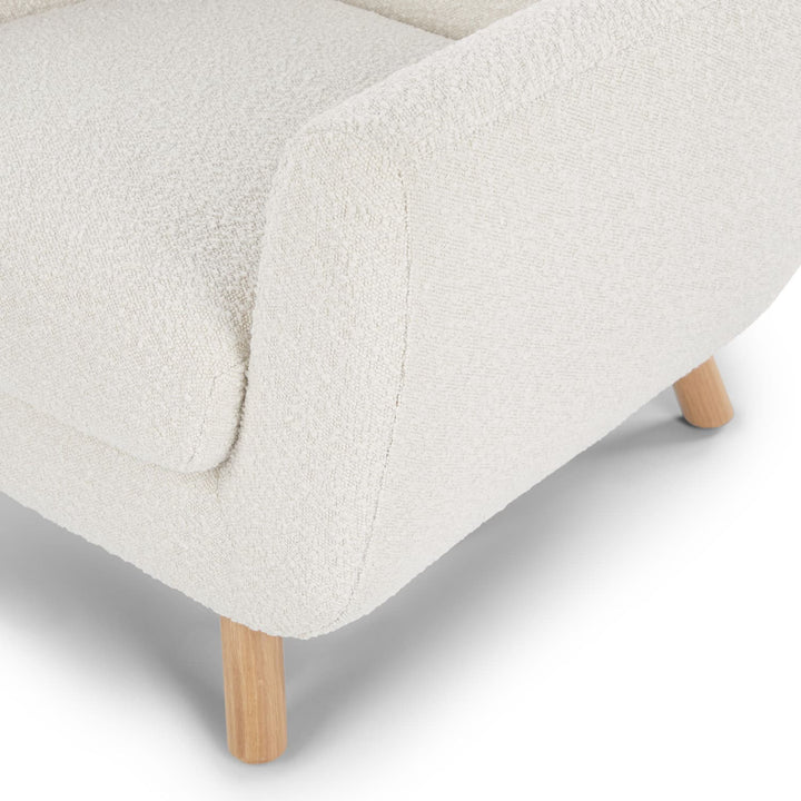 Santorini bouclé lounge chair in emerald green with curved wood frame in modern living room