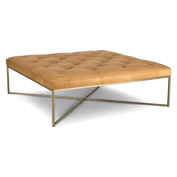 Sarek Leather Square Ottoman in an industrial-chic living room with brass legs and tufted leather