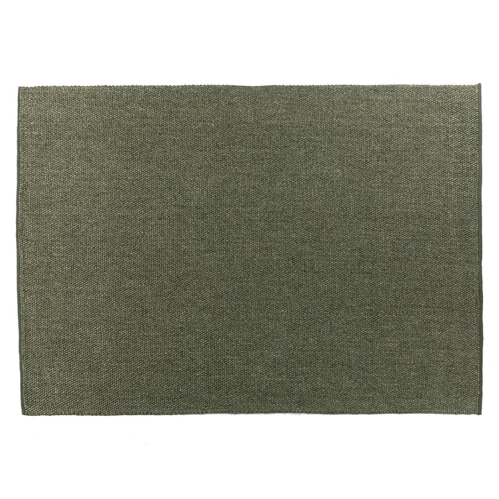 Silvanus Hand-Woven Wool Rug in a bohemian living room with wood floors and neutral decor