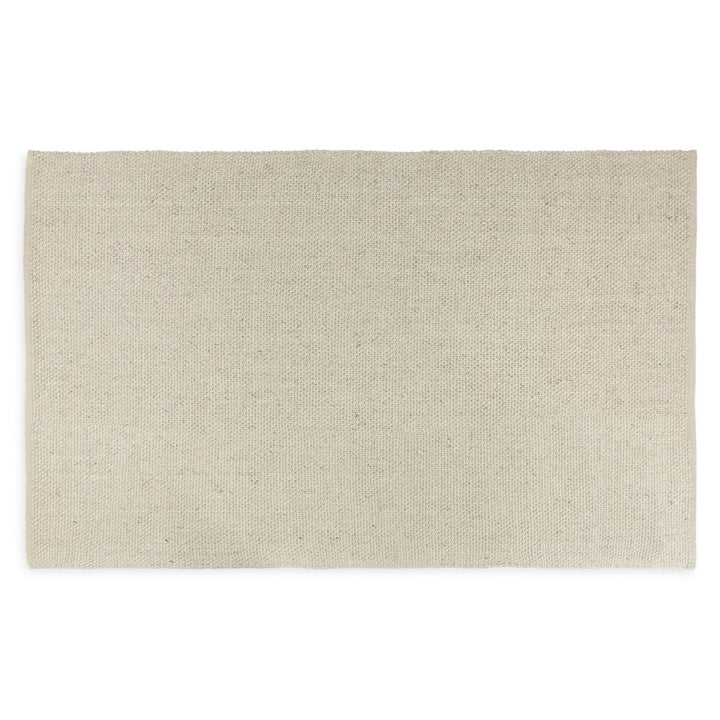 Silvanus Hand-Woven Wool Rug in a bohemian living room with wood floors and neutral decor