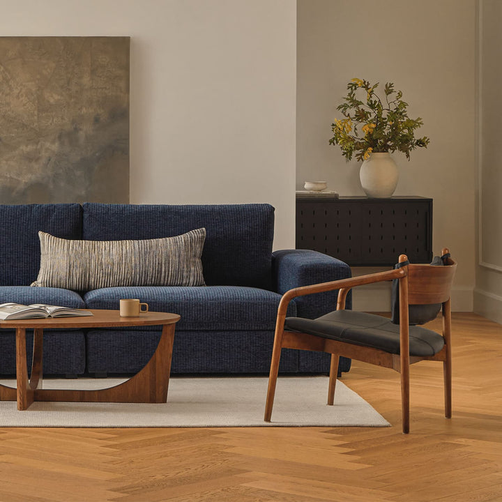 Solstice Leather Lounge Chair in tan patina leather with walnut legs in mid-century living room