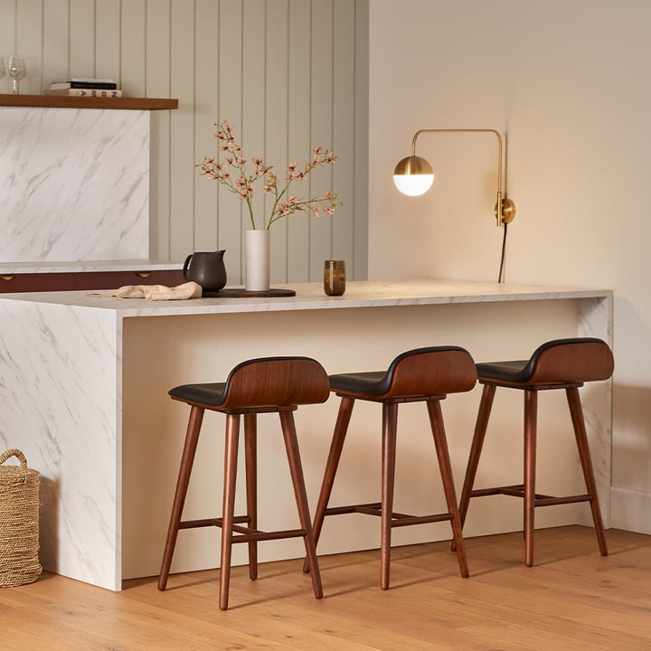 Stria Leather Counter Stool in a mid-century modern kitchen with tapered legs and Toscana leather seat