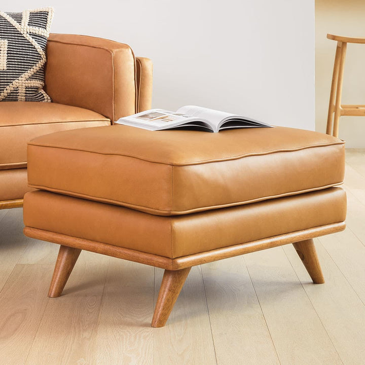 Svartur Leather Ottoman in a mid-century modern living room with aniline leather and wood legs